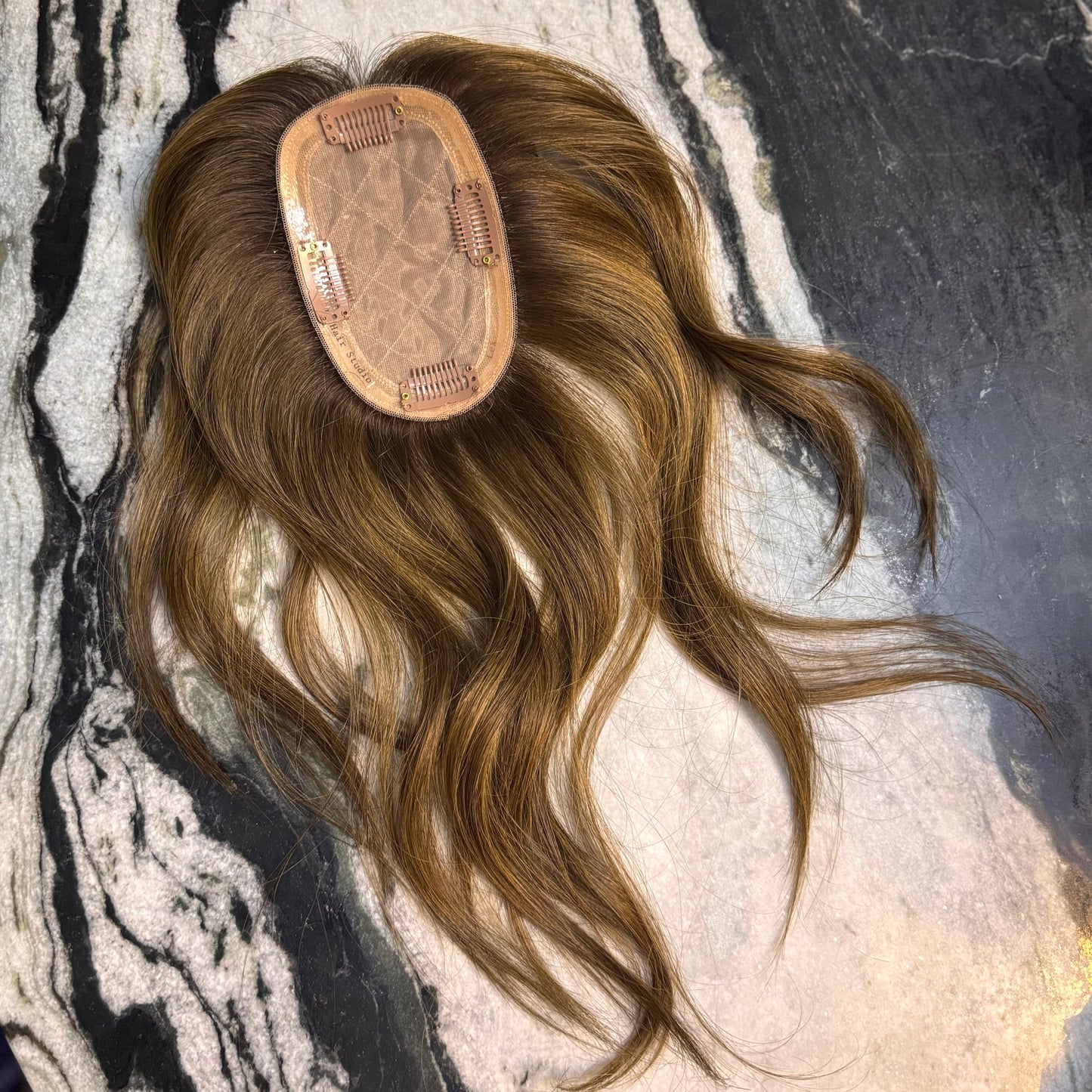 Underside of the 3×5 Skin Top Hair Topper featuring a breathable base, secure clip placement, and 100% European Remy human hair in Chestnut Brown with soft honey highlights.