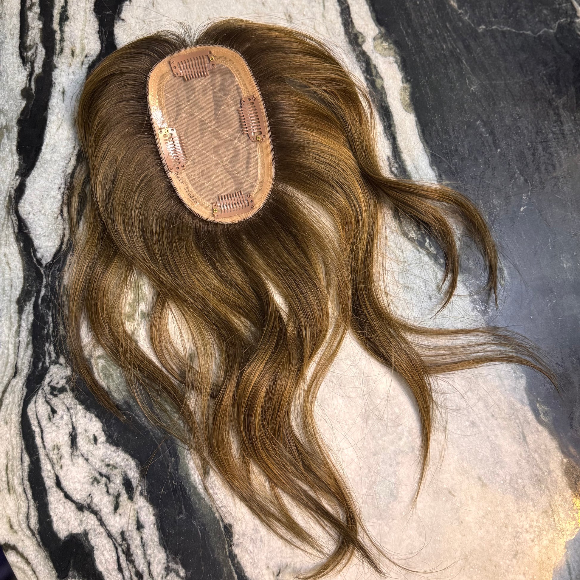 Underside of the 3×5 Skin Top Hair Topper featuring a breathable base, secure clip placement, and 100% European Remy human hair in Chestnut Brown with soft honey highlights.