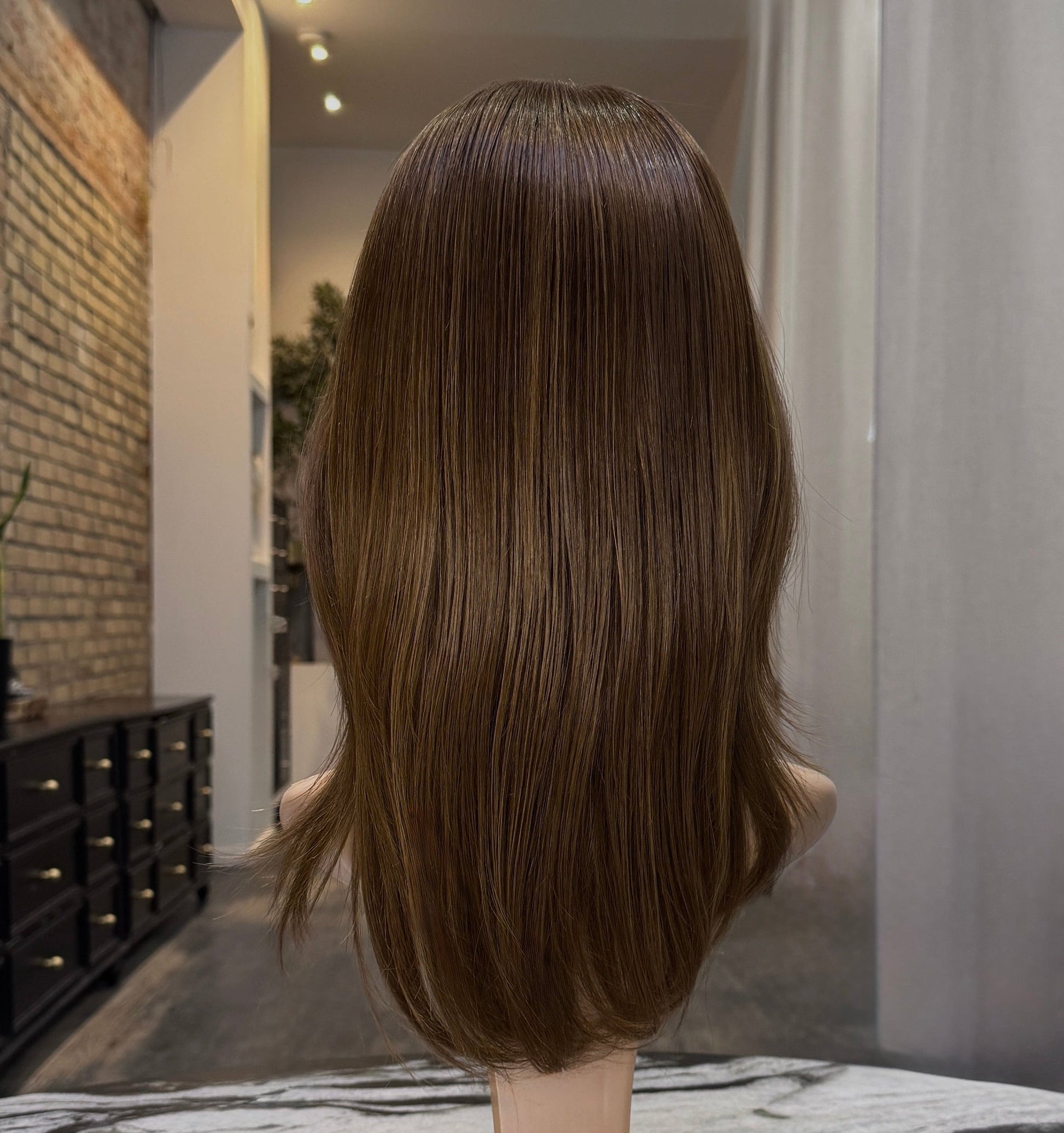 Premium auburn red human hair wig with smooth, natural finish back view